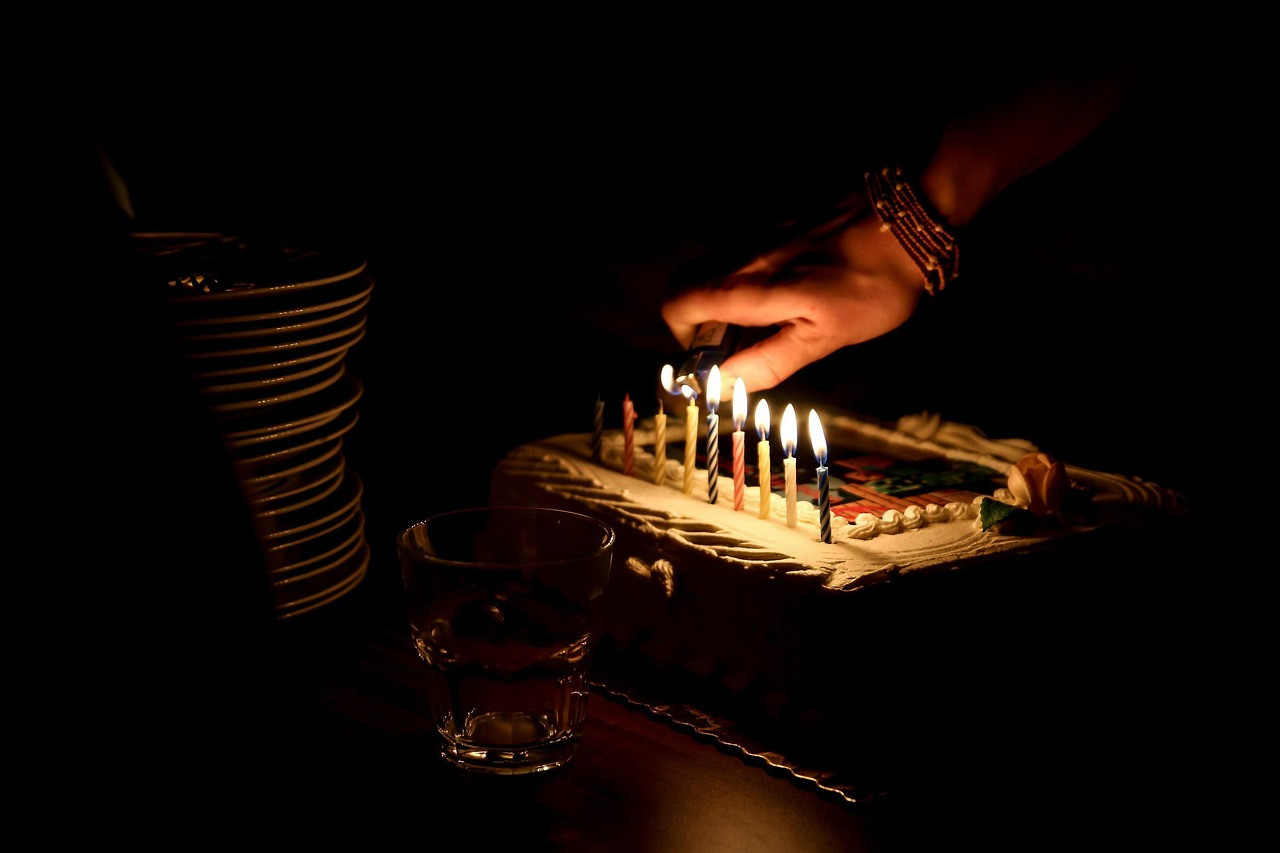 lighting candles over cake